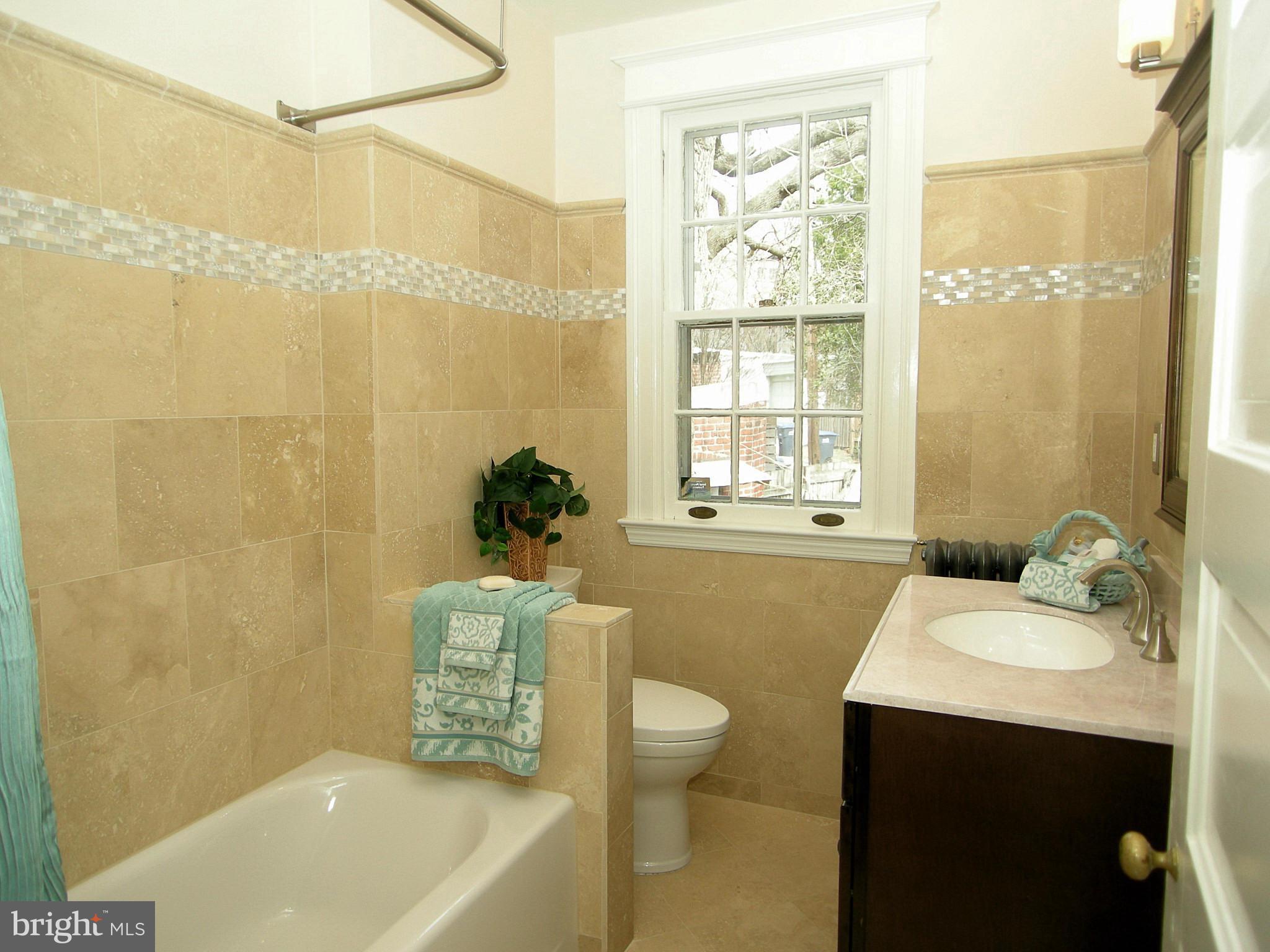 2815 Woodley Road Northwest Washington, DC 20008 - Photo 15 of 25 a bathroom with a sink a toilet and a bathtub