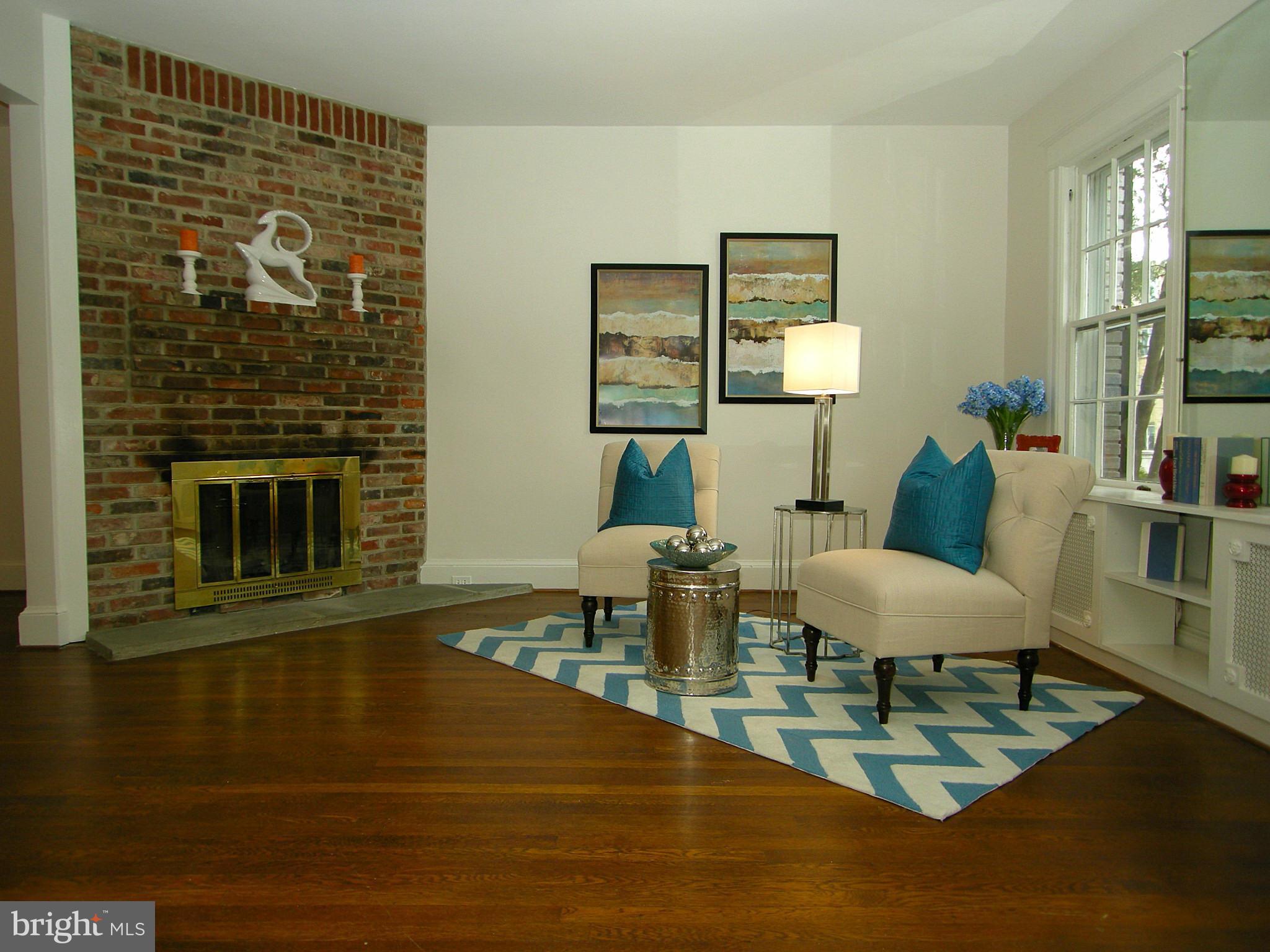 2815 Woodley Road Northwest Washington, DC 20008 - Photo 4 of 25 a living room with fireplace furniture and a wooden floor