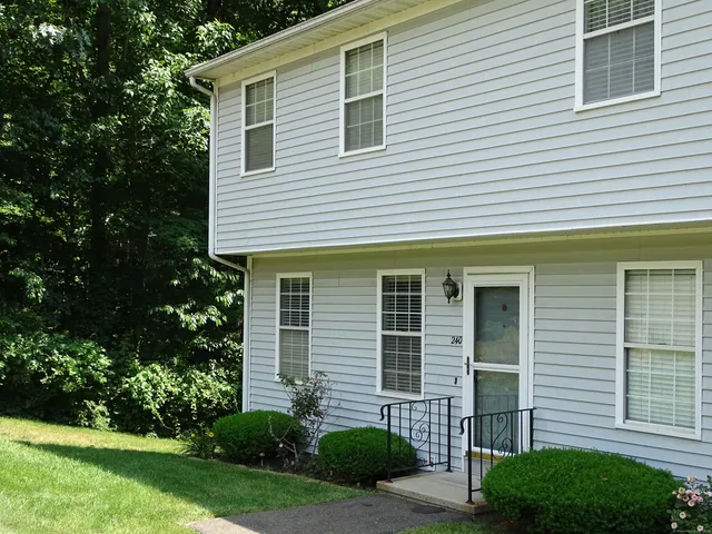 a front view of a house with a yard and outdoor seating