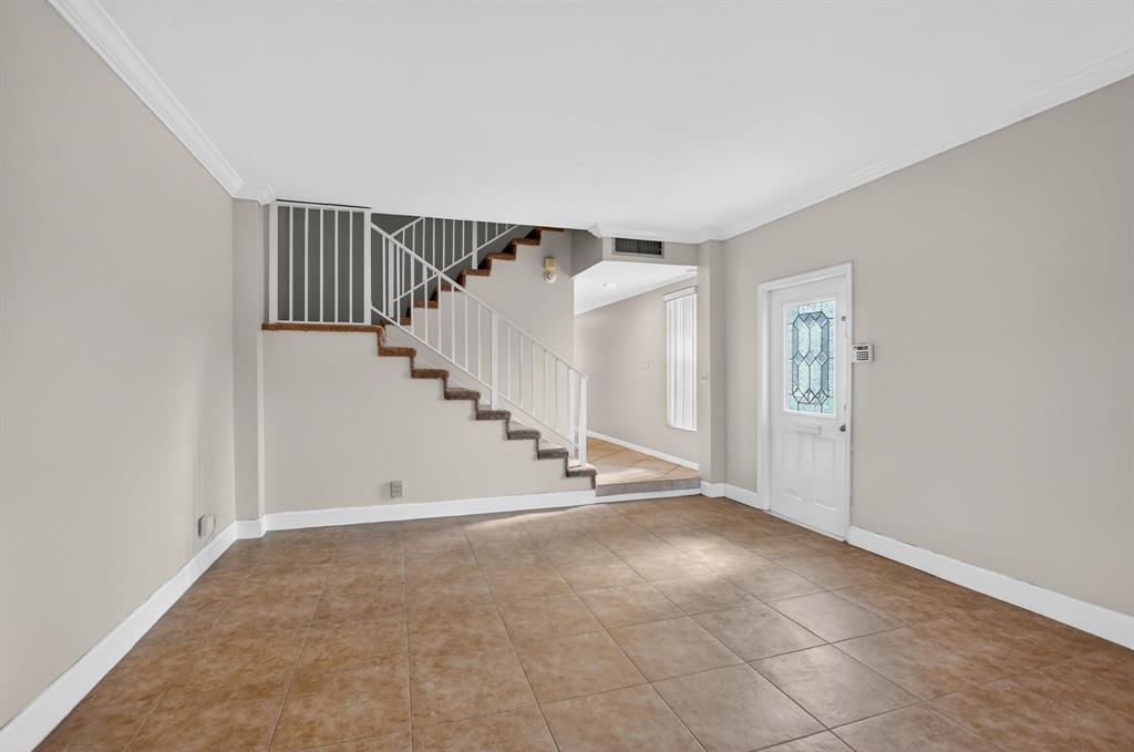 596 Southeast 20th Avenue, Unit 4 Deerfield Beach, FL 33441 - Photo 12 of 51 a view of an empty room with stairs