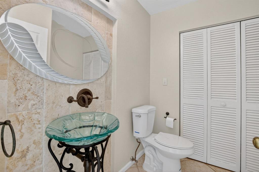 596 Southeast 20th Avenue, Unit 4 Deerfield Beach, FL 33441 - Photo 23 of 51 a bathroom with a toilet a sink and a mirror