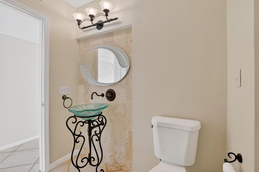 596 Southeast 20th Avenue, Unit 4 Deerfield Beach, FL 33441 - Photo 24 of 51 a bathroom with a granite countertop bathtub sink vanity and toilet