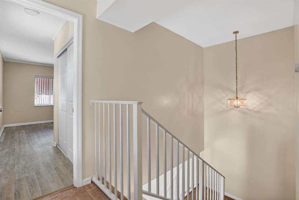 596 Southeast 20th Avenue, Unit 4 Deerfield Beach, FL 33441 - Photo 26 of 51 a view of a hallway with wooden floor and staircase