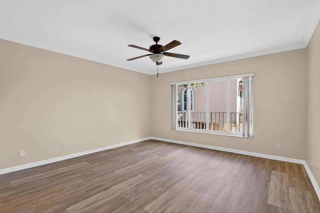 596 Southeast 20th Avenue, Unit 4 Deerfield Beach, FL 33441 - Photo 30 of 51 a view of an empty room with wooden floor and a window