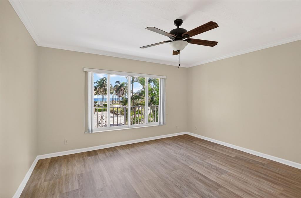 596 Southeast 20th Avenue, Unit 4 Deerfield Beach, FL 33441 - Photo 33 of 51 an empty room with wooden floor fan and windows