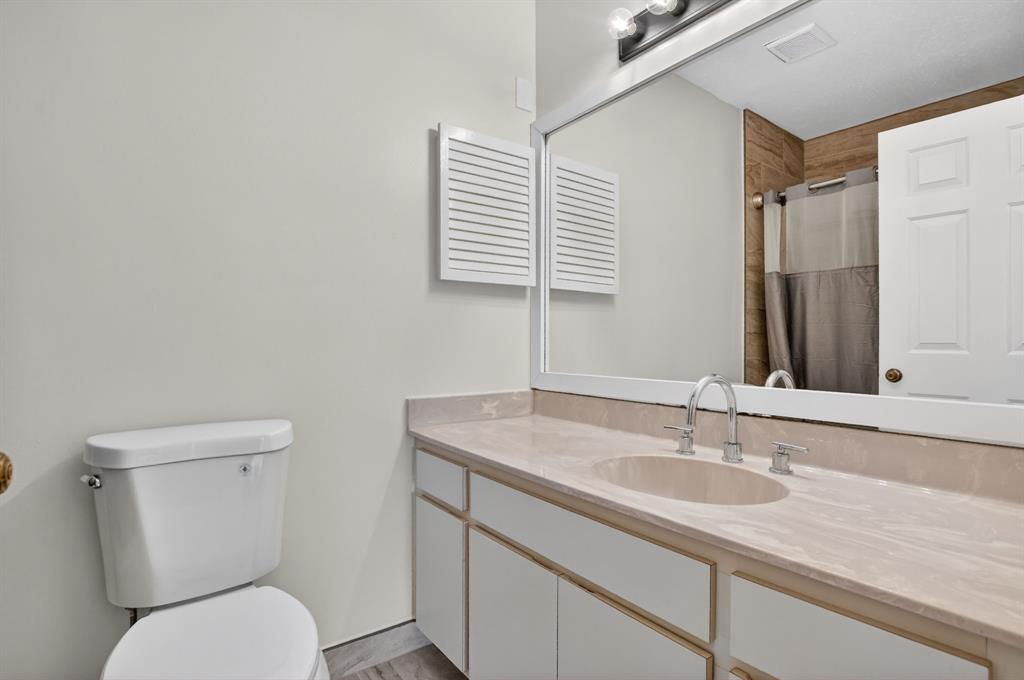 596 Southeast 20th Avenue, Unit 4 Deerfield Beach, FL 33441 - Photo 37 of 51 a bathroom with a toilet sink and mirror