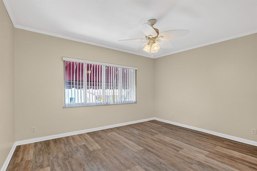596 Southeast 20th Avenue, Unit 4 Deerfield Beach, FL 33441 - Photo 40 of 51 wooden floor in an empty room with a window
