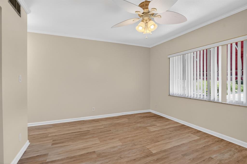 596 Southeast 20th Avenue, Unit 4 Deerfield Beach, FL 33441 - Photo 42 of 51 a view of an empty room with window and wooden floor