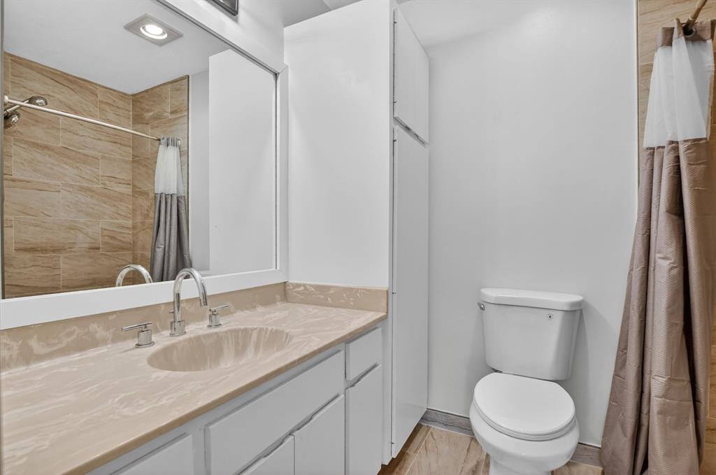 596 Southeast 20th Avenue, Unit 4 Deerfield Beach, FL 33441 - Photo 44 of 51 a bathroom with a granite countertop sink toilet and shower