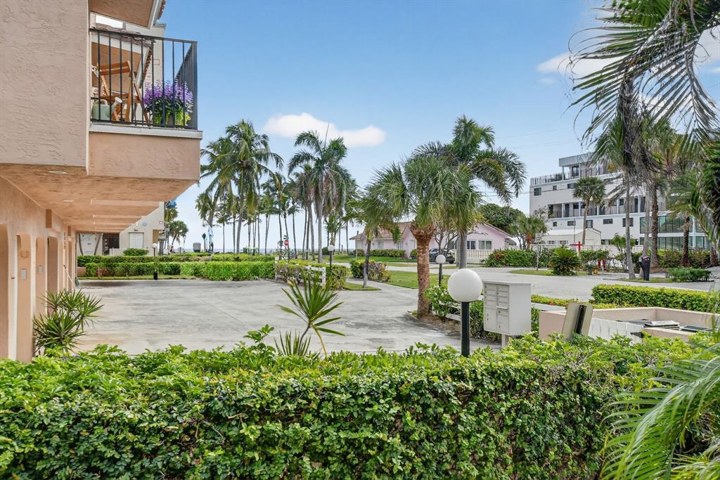 596 Southeast 20th Avenue, Unit 4 Deerfield Beach, FL 33441 - Photo 51 of 51 a view of a swimming pool with a bench and trees