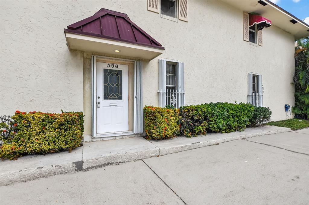 596 Southeast 20th Avenue, Unit 4 Deerfield Beach, FL 33441 - Photo 8 of 51 a view of a house with a flower garden