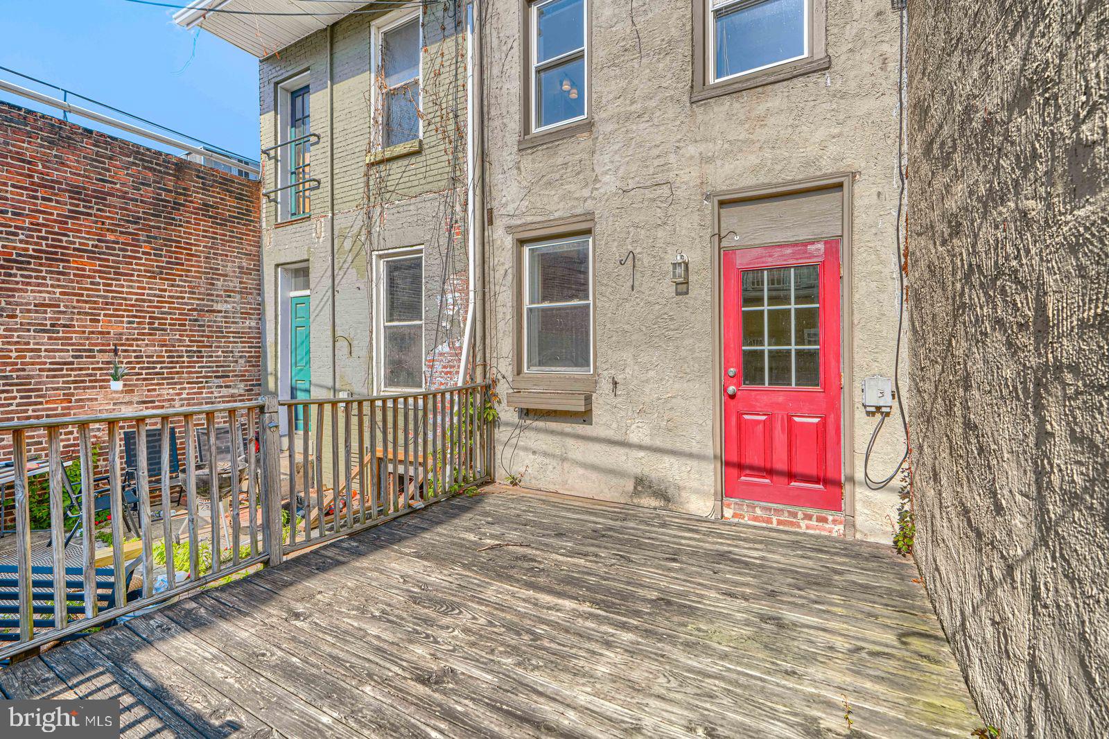 1026 Patapsco Street Baltimore, MD 21230 - Photo 10 of 24 a view of a brick building with a red gate
