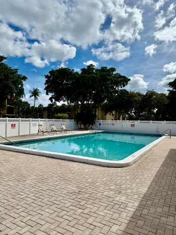 a view of yard with swimming pool and trees