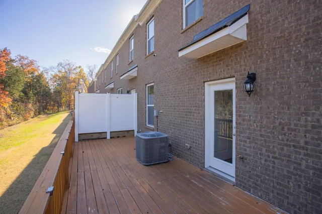 a view of an outdoor space with wooden floor and a yard