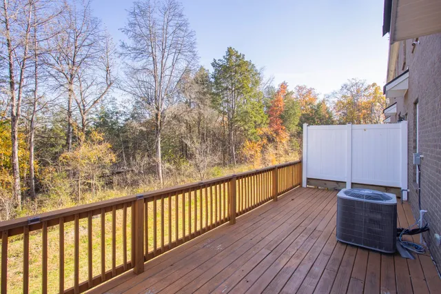 a view of balcony with wooden floor and fence