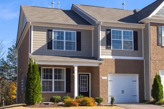 front view of a brick house with a large windows