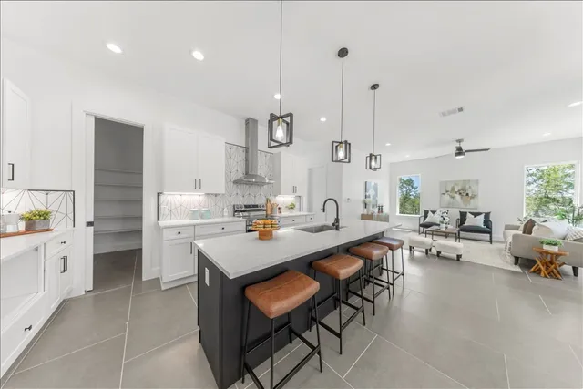 a large kitchen with lots of counter space a sink appliances and a counter space