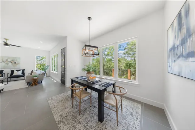 a kitchen with cabinets a sink and chairs