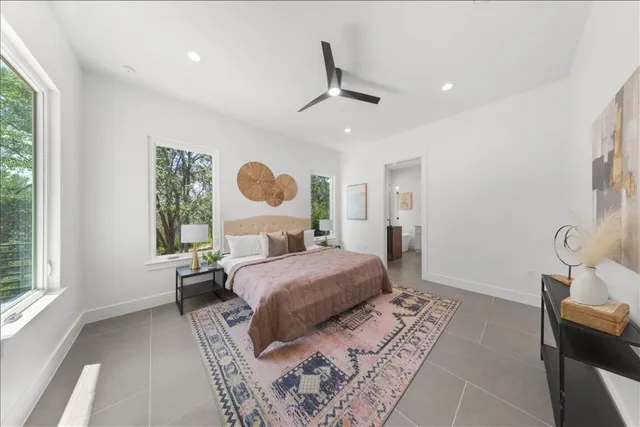 a spacious bathroom with a granite countertop sink and a bathtub