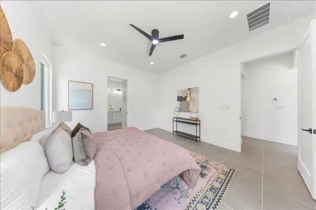 a bedroom with a large bed and a window