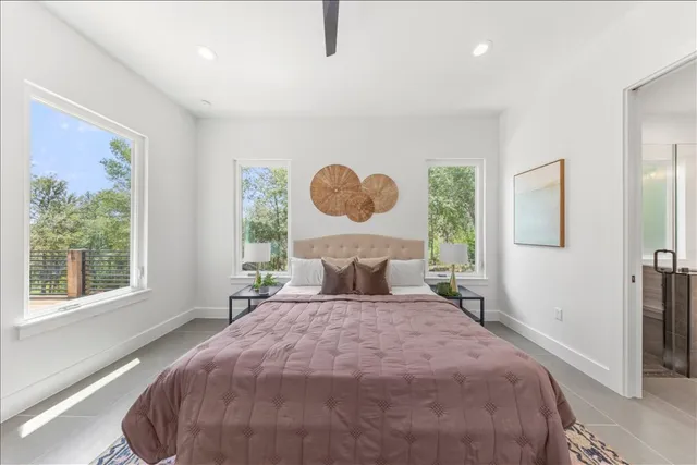 a bedroom with a bed and a chandelier