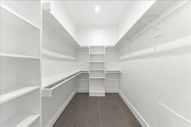 a spacious bathroom with a double vanity sink a mirror and a bathtub