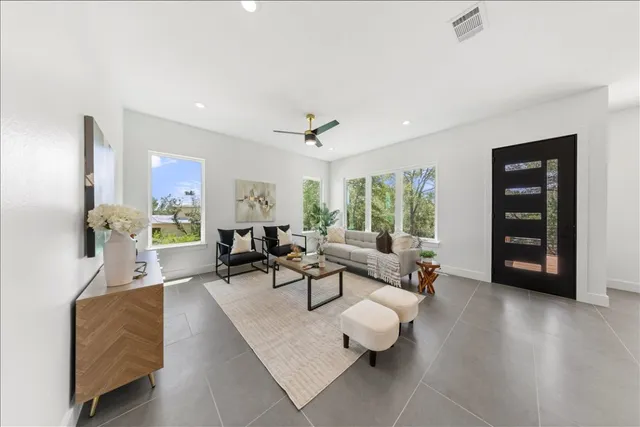 a living room with furniture and wooden floor