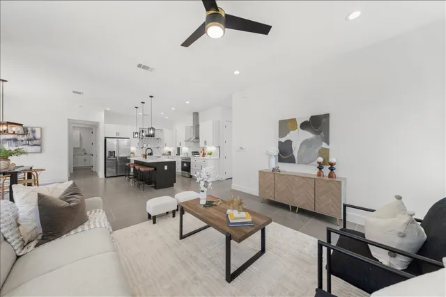 a living room with furniture and view of kitchen