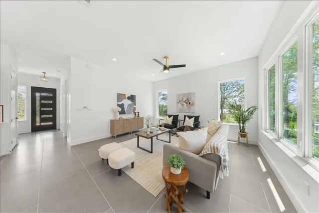 a living room with furniture and wooden floor