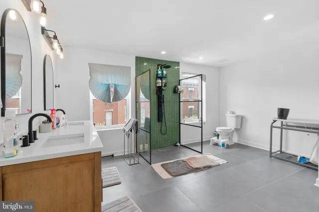 a bathroom with a sink toilet and shower