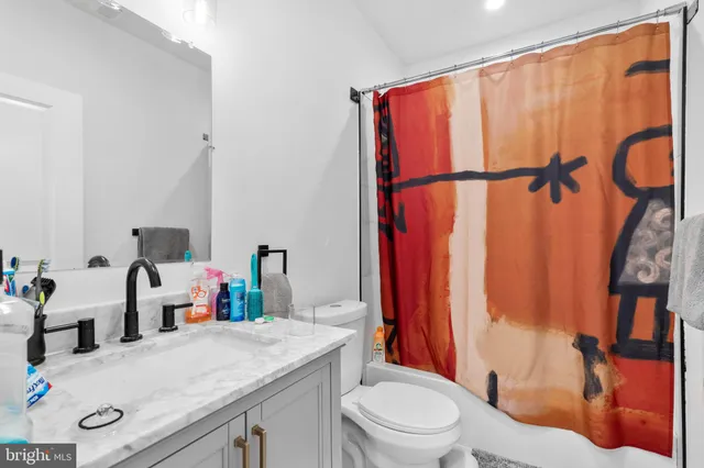 a living room with furniture and a book shelf