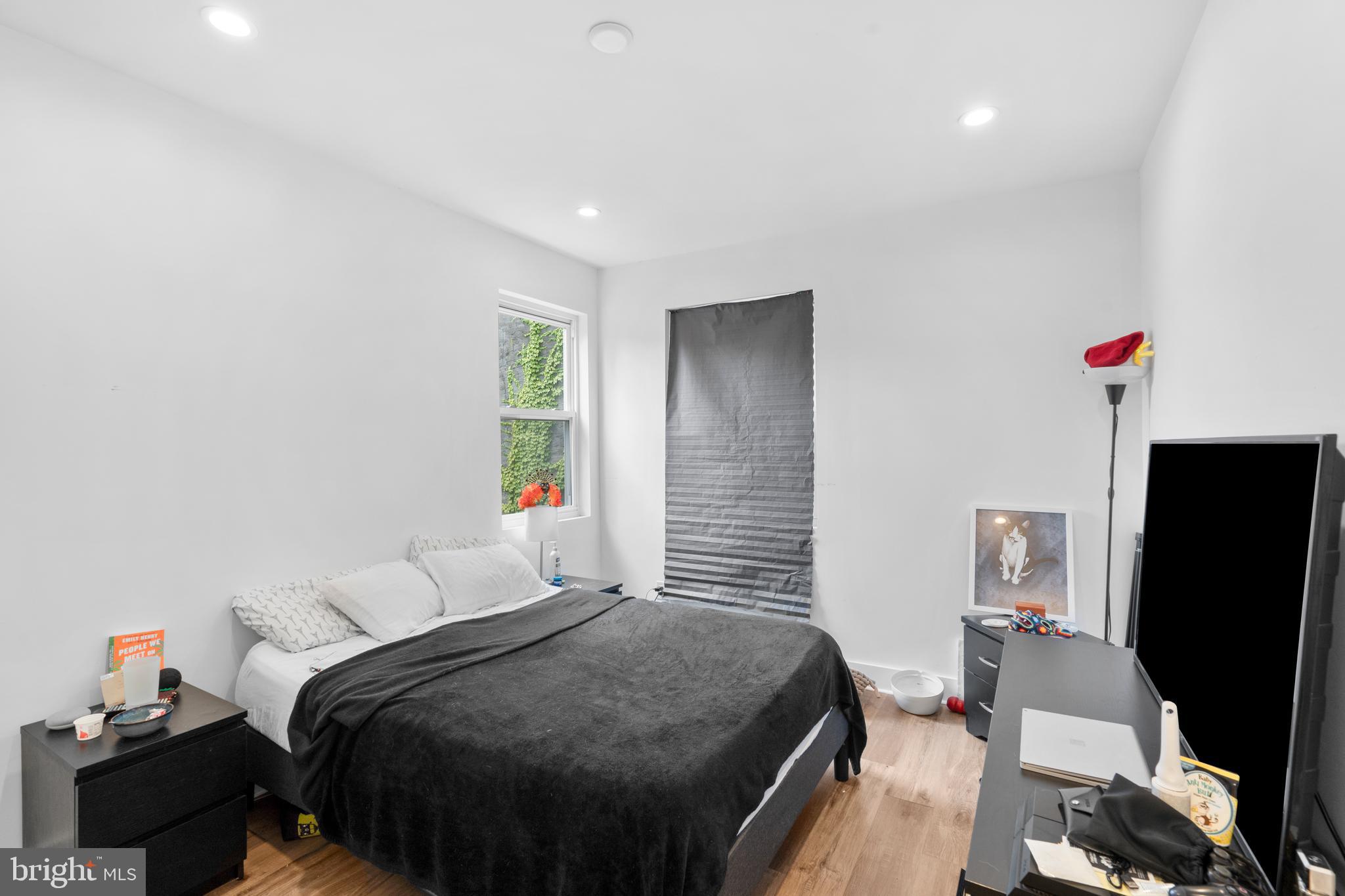 952 North 5th Street Philadelphia, PA 19123 - Photo 23 of 49 a bedroom with a bed and a flat screen tv