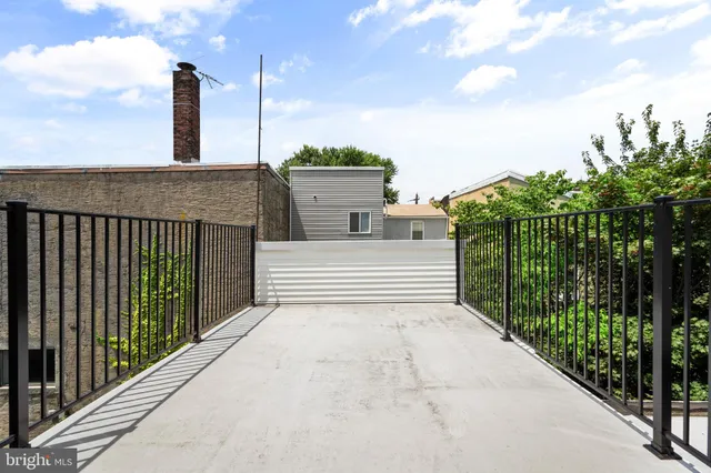 a terrace with outdoor seating and city view
