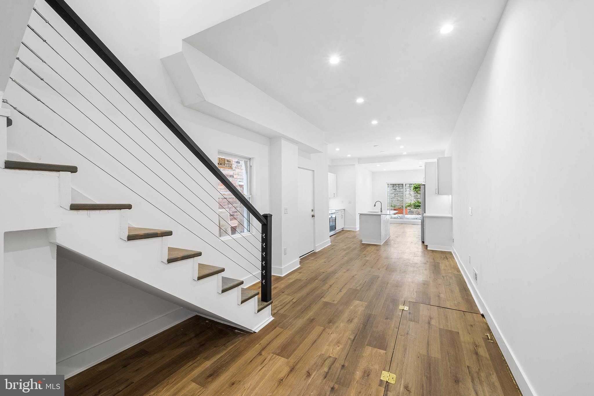 952 North 5th Street Philadelphia, PA 19123 - Photo 35 of 49 a view of a hallway with wooden floor and staircase