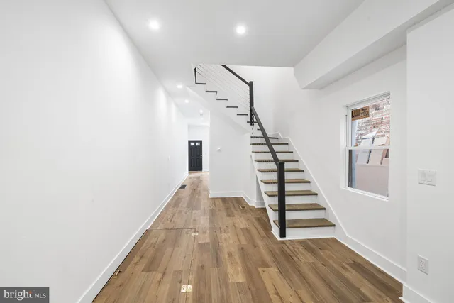 a kitchen with stainless steel appliances a sink a stove a microwave a center island and cabinets