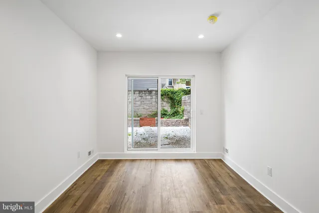 a view of brick house with potted plants
