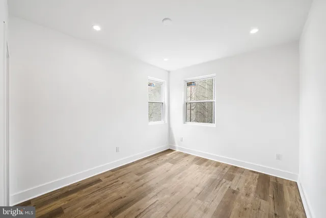 a bathroom with a sink and mirror with bathtub