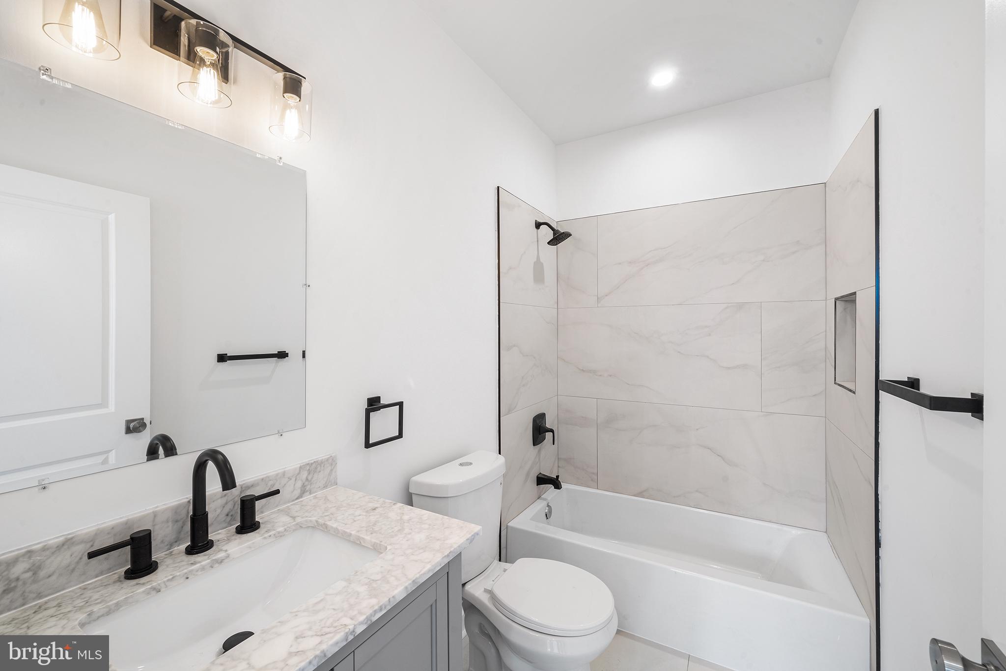 952 North 5th Street Philadelphia, PA 19123 - Photo 44 of 49 a bathroom with a granite countertop bathtub shower sink vanity and toilet
