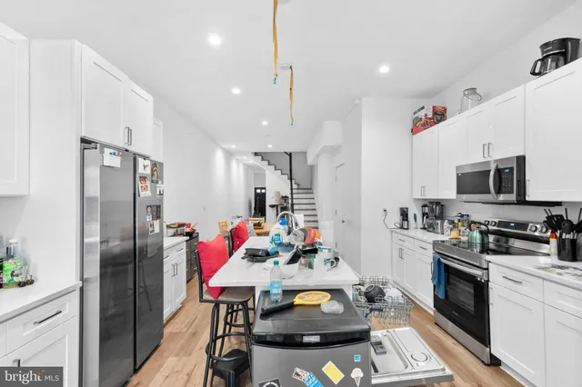 a kitchen with stainless steel appliances granite countertop a refrigerator sink stove and microwave