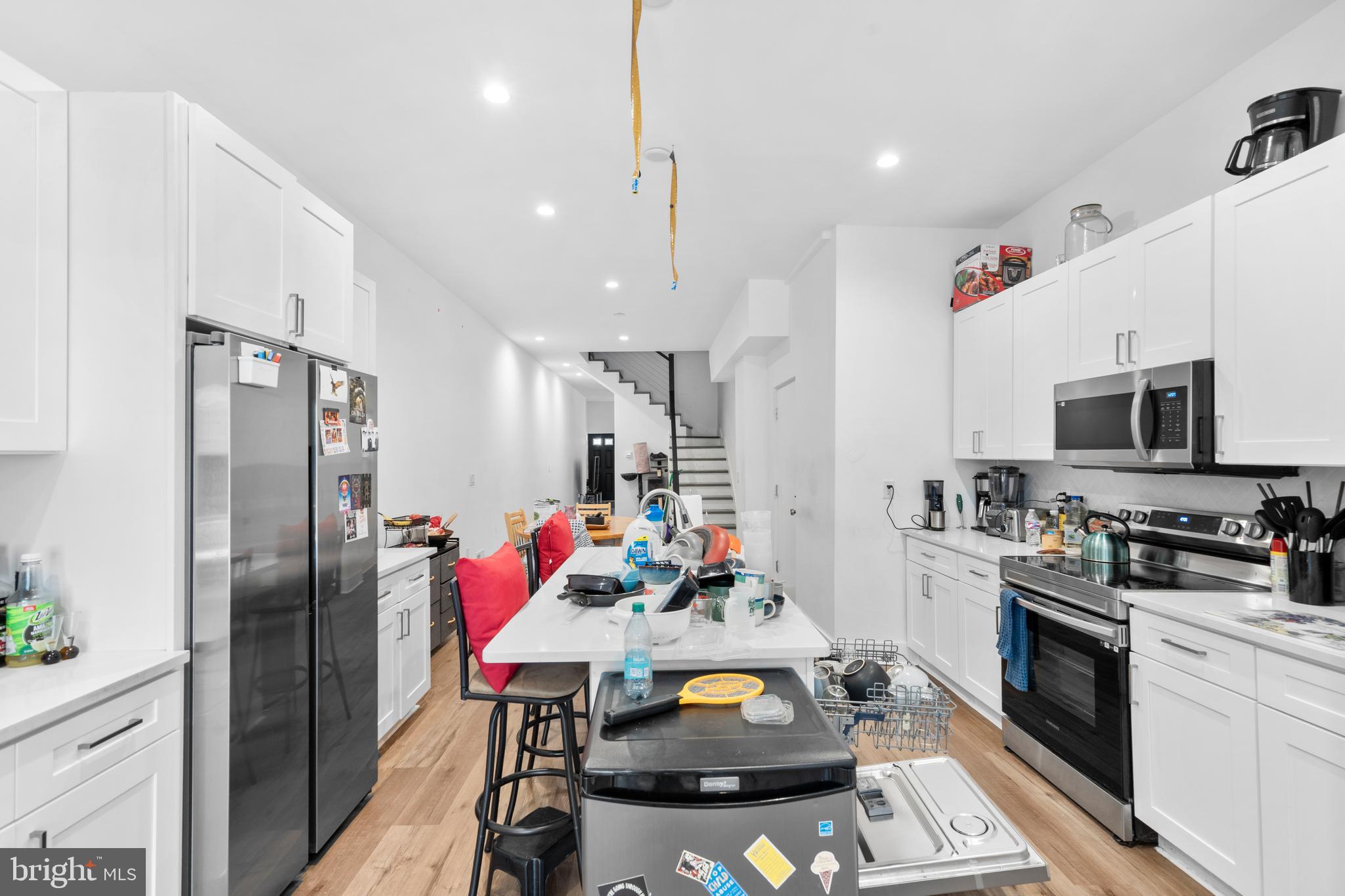 952 North 5th Street Philadelphia, PA 19123 - Photo 6 of 49 a kitchen with stainless steel appliances granite countertop a refrigerator sink stove and microwave