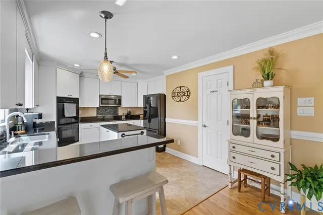 a kitchen with stainless steel appliances granite countertop a sink a stove and a refrigerator