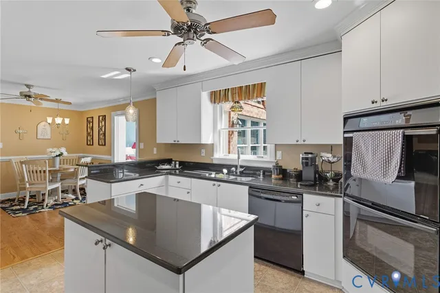 a kitchen with granite countertop stainless steel appliances a sink a counter top space cabinets and a window