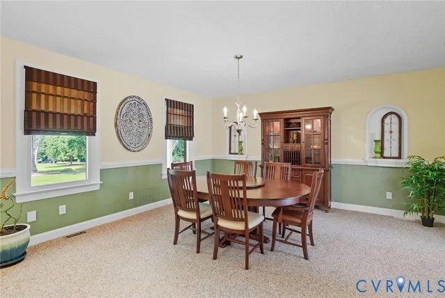a view of a dining room with furniture and a window