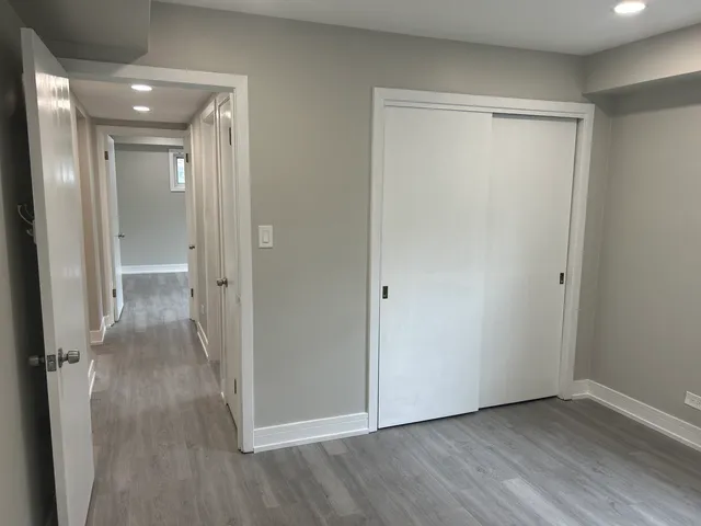 a view of a room with wooden floor