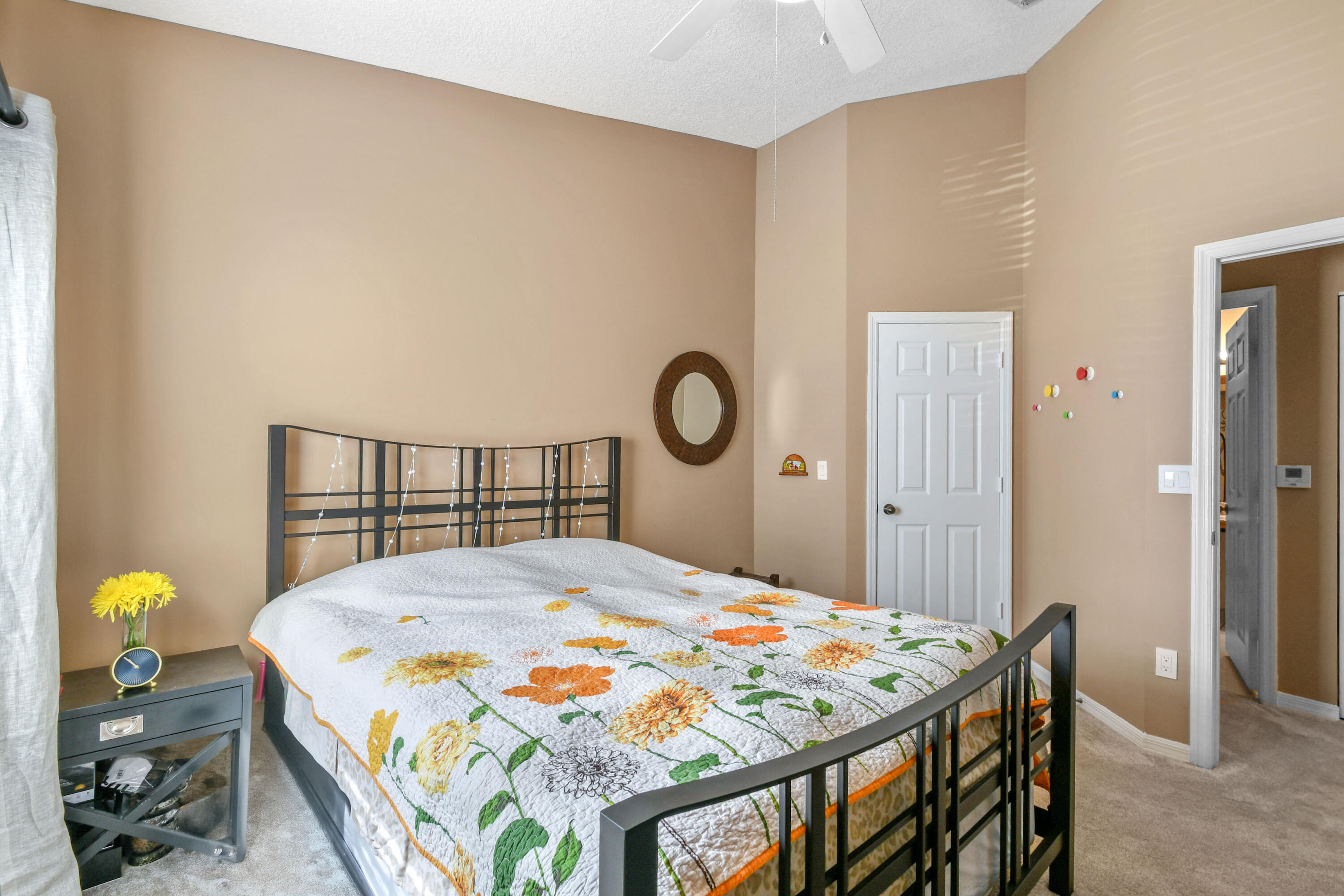 10354 Fox Trail Road South, Unit 1505 West Palm Beach, FL 33411 - Photo 19 of 76 a bedroom with a bed and a chandelier