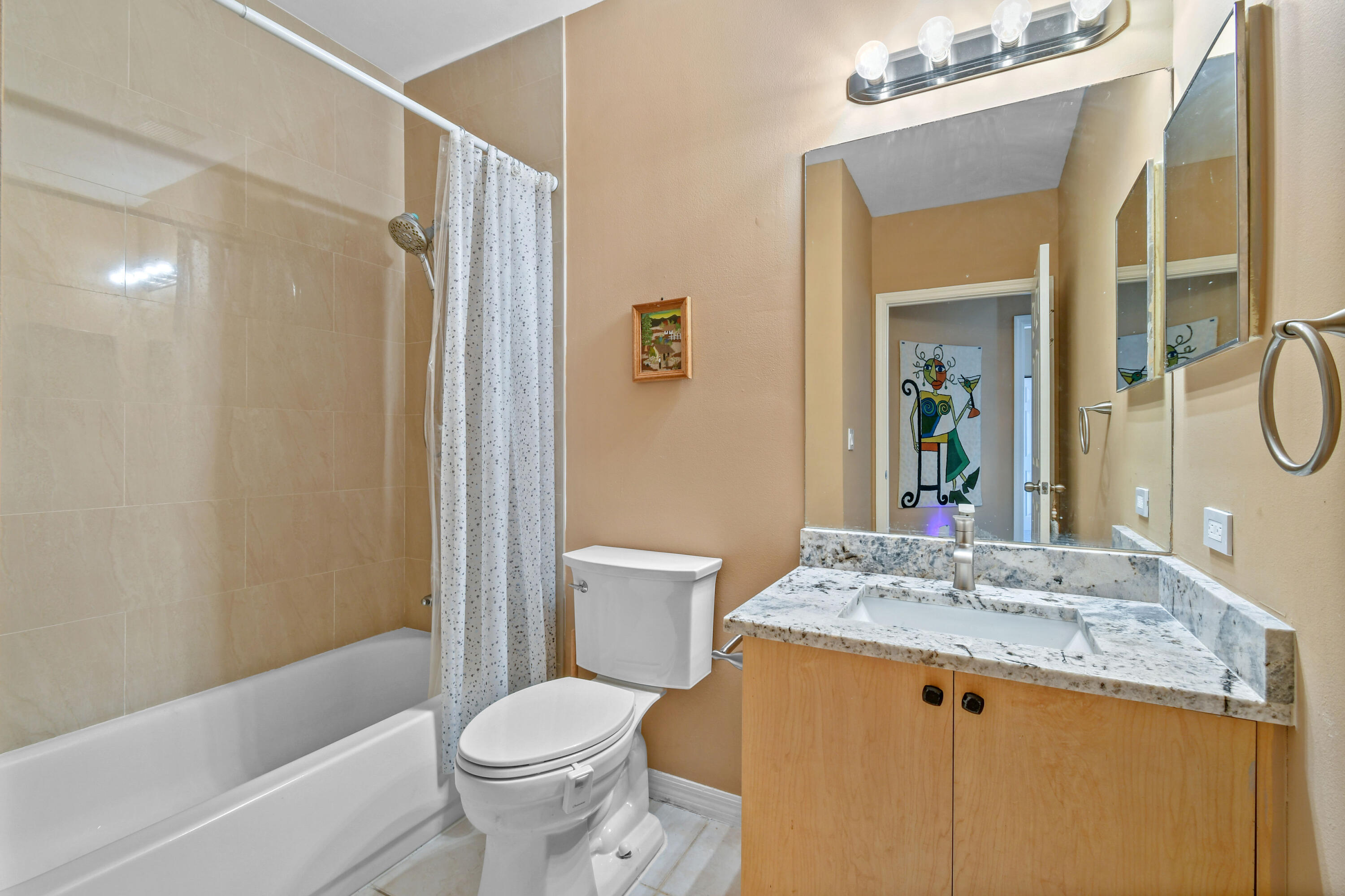 10354 Fox Trail Road South, Unit 1505 West Palm Beach, FL 33411 - Photo 20 of 76 a bathroom with a granite countertop sink toilet and shower