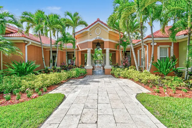 a front view of a house with a yard and trees