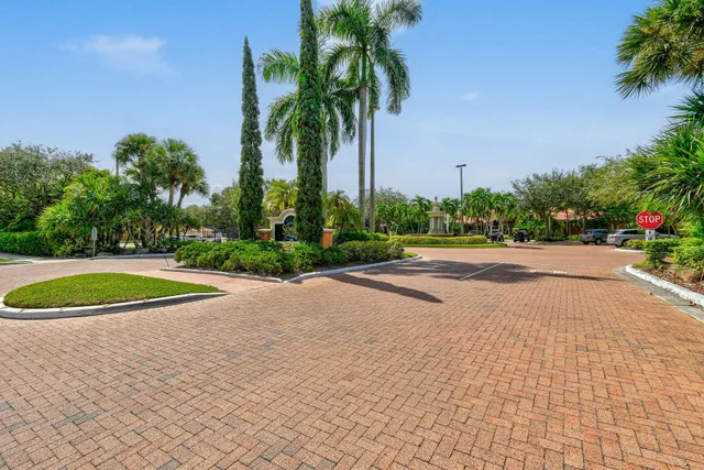 a kitchen with stainless steel appliances kitchen island granite countertop a refrigerator and a stove top oven