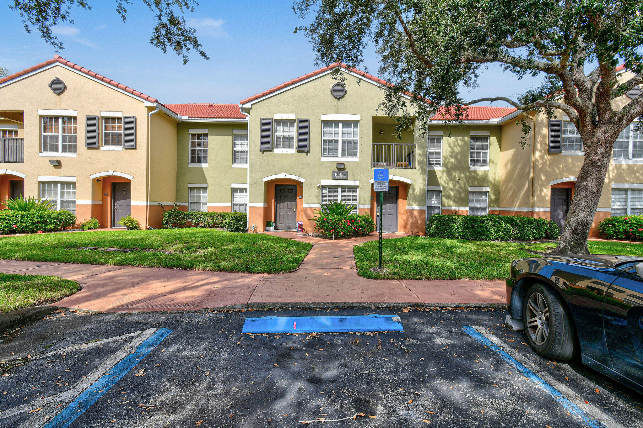 10354 Fox Trail Road South, Unit 1505 West Palm Beach, FL 33411 - Photo 37 of 76 a front view of a house with a yard and garage