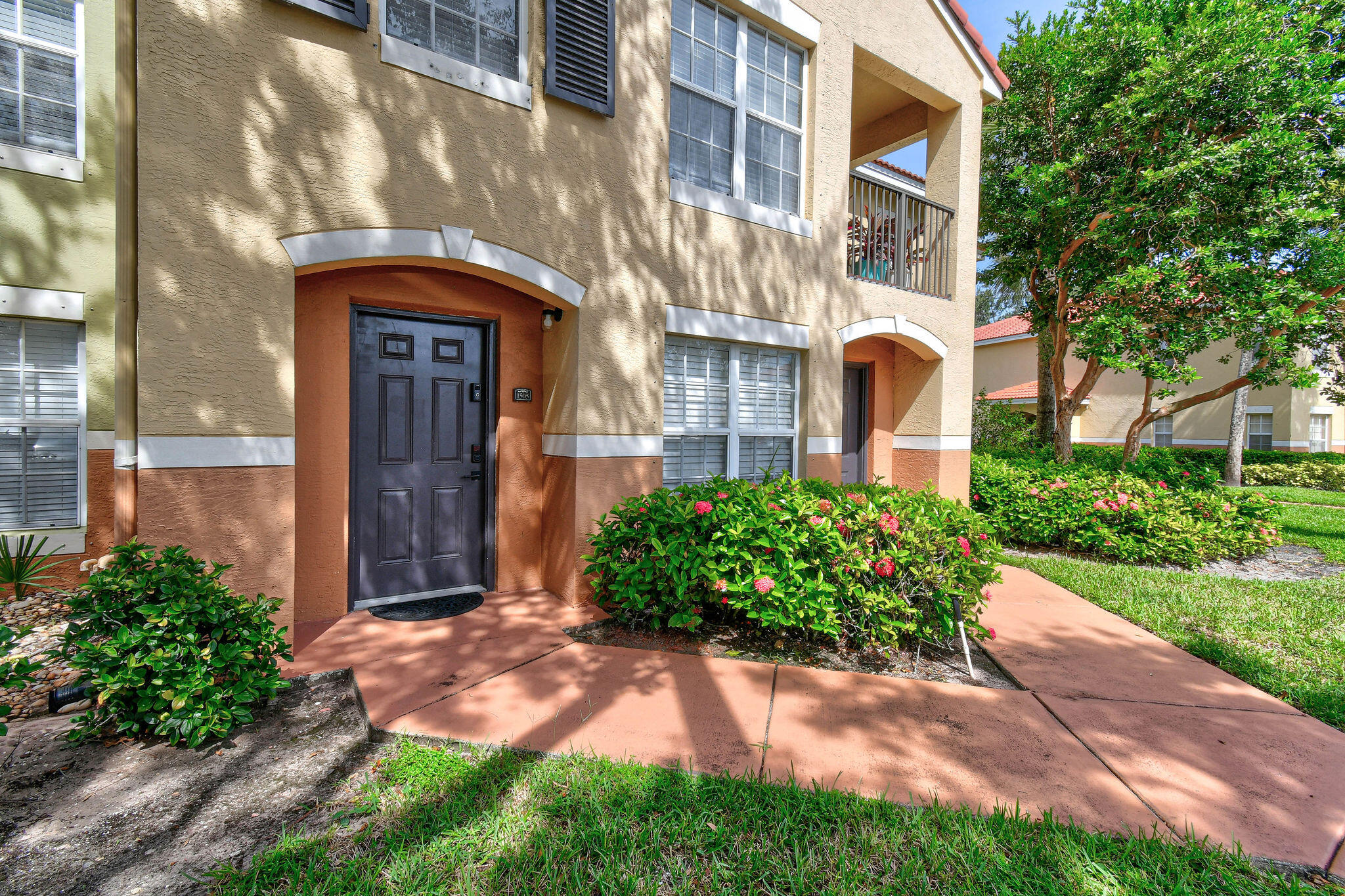 10354 Fox Trail Road South, Unit 1505 West Palm Beach, FL 33411 - Photo 40 of 76 a front view of a house with garden